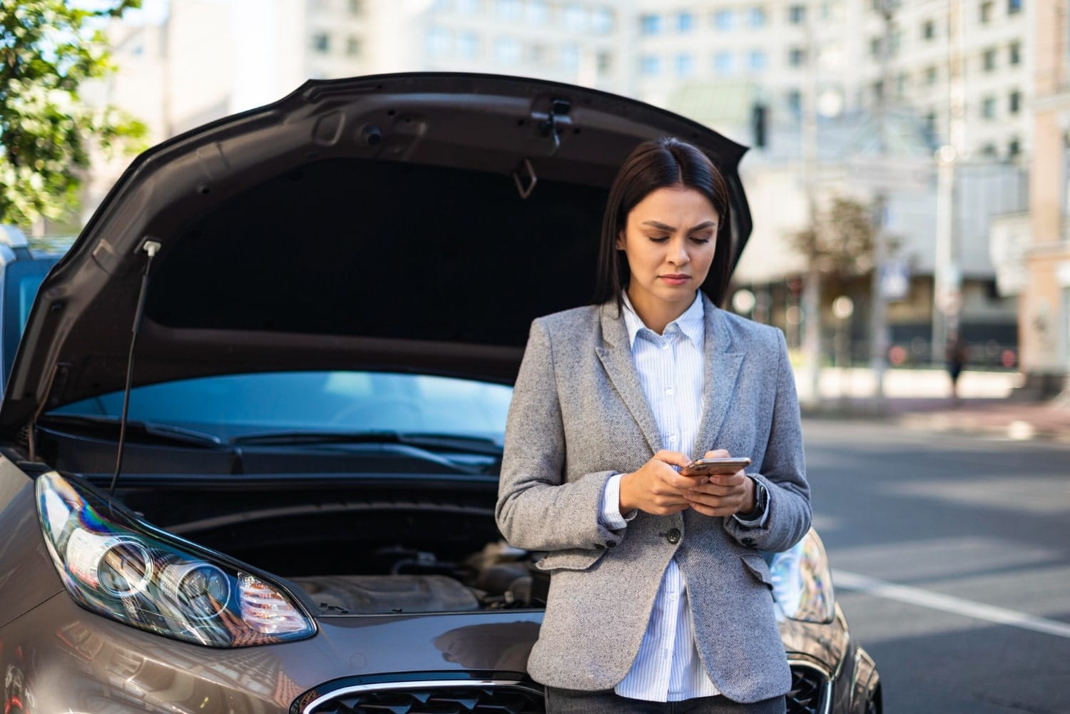 woman in front of a broken car
