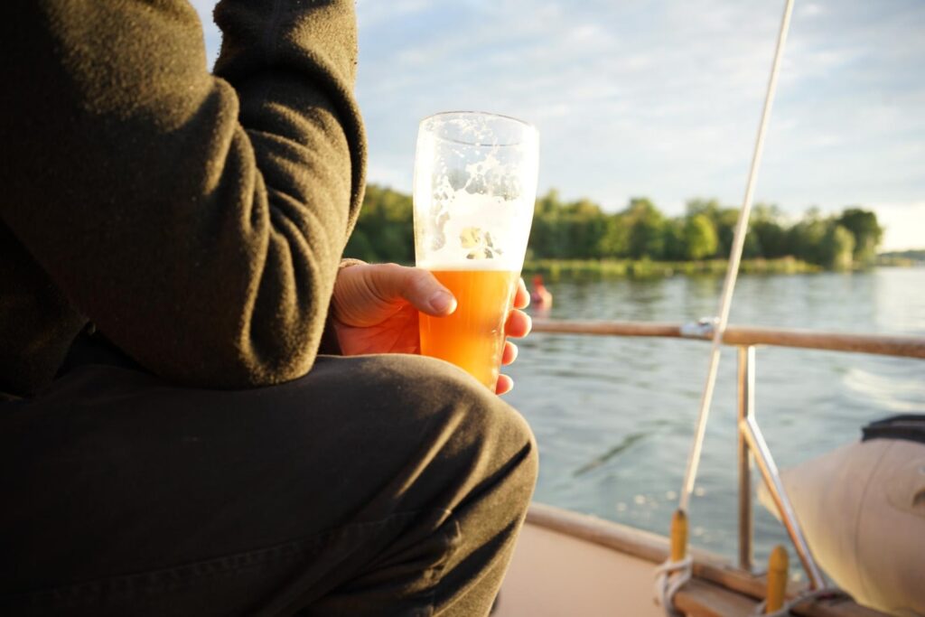 man having a beer on a boat