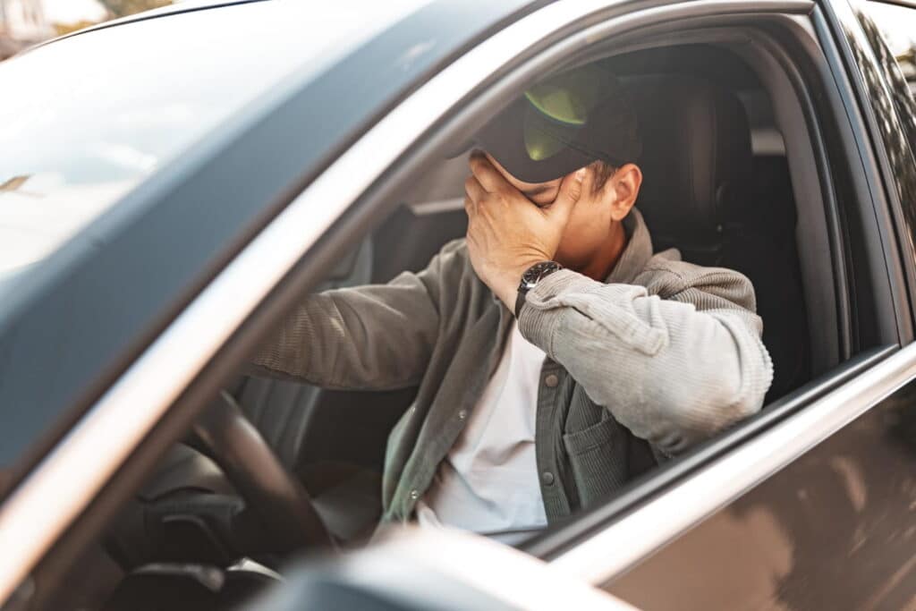 drunk man sitting in his car