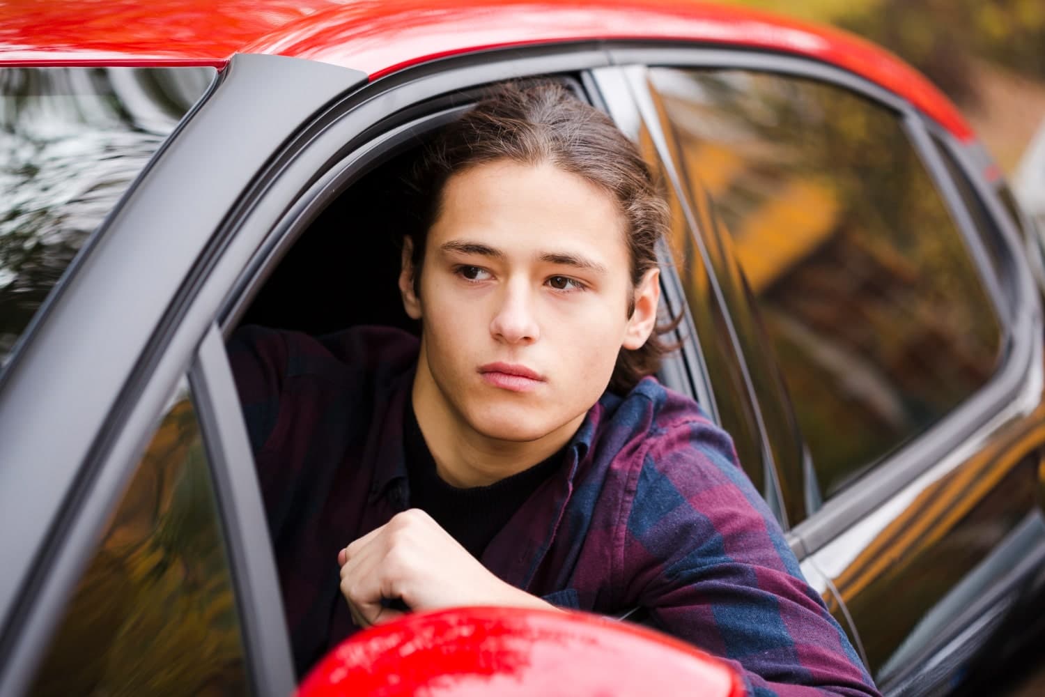teenager looking out of car window